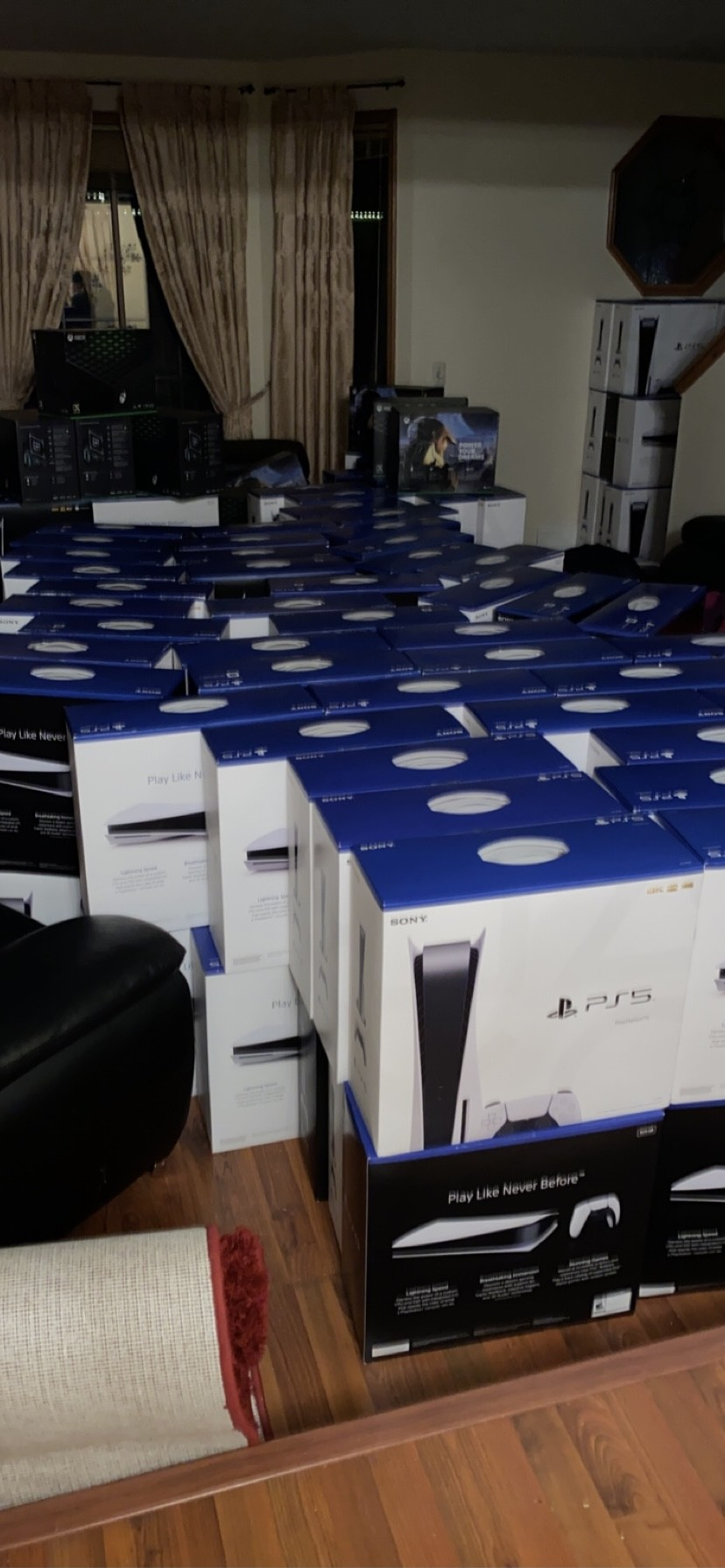 Room filled with PS5 console inventory showing business scale